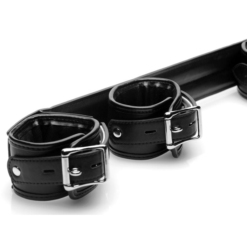 Black cushioned cuffs on a deluxe spreader bar for bondage, designed for enhanced comfort and restraint.