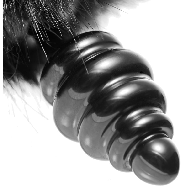 Close-up of a black bunny tail anal plug with tapered tip and stimulating ripples.
