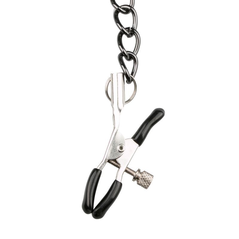 Close-up of a metal nipple clamp connected by chains, part of a collar with nipple clamps for SM play.