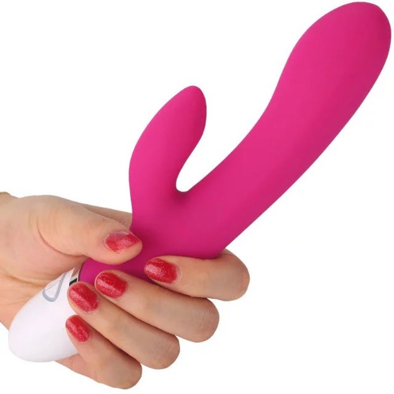 Hand holding a pink rechargeable rabbit vibrator, showcasing its ergonomic design and silicone material.