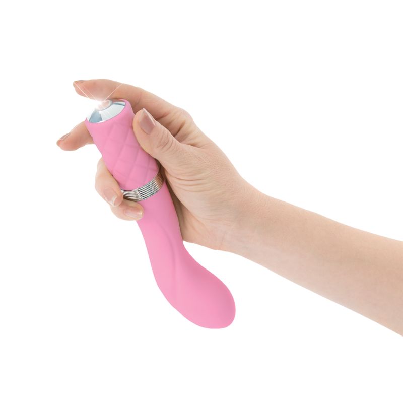 Person holding a Sassy pink G-spot vibrator showcasing its elegant design and ergonomic features.