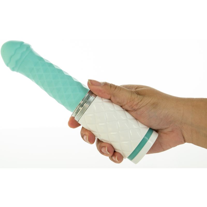 Hand holding the Teal Pillow Talk thrusting vibrator with a diamond pattern handle.