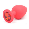 Large red silicone anal plug featuring a sparkling red diamond for pleasure and style.