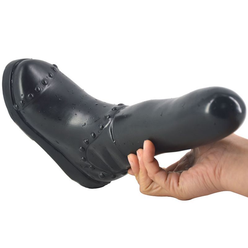 Boot Dildo Black held in hand, showcasing its realistic design and easy-to-clean material for intimate essentials for her.