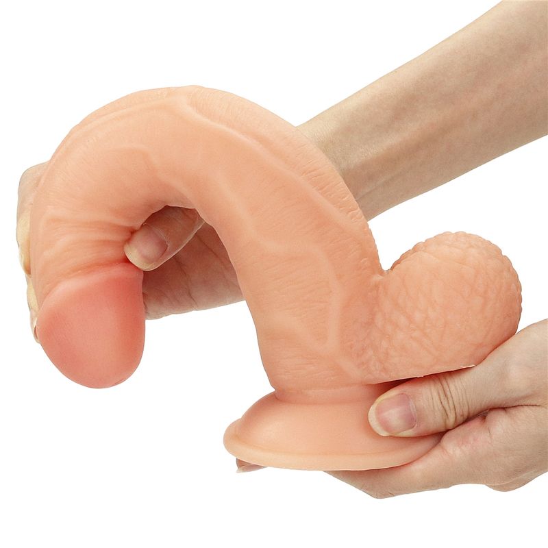Realistic strap on dildo set held in hand showcasing lifelike texture and design for maximum satisfaction.