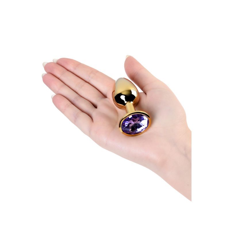 Gold Metal Anal Plug w Amethyst Crystal Small held in hand showcasing its luxury design and size.