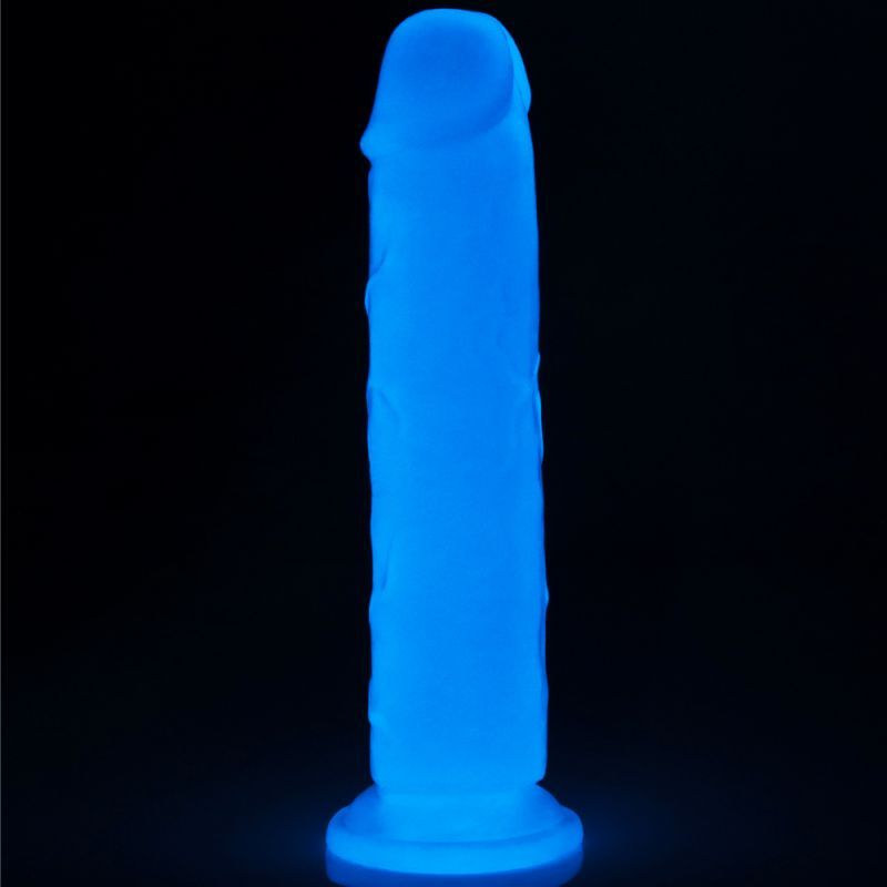 Glow in the dark dildo glowing blue against a dark background, showcasing thrilling pleasure features.