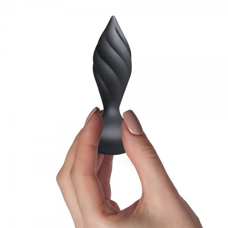 Hand holding the Petite Sensation Desire butt plug, a sleek, black petite vibrating butt plug designed for pleasure.