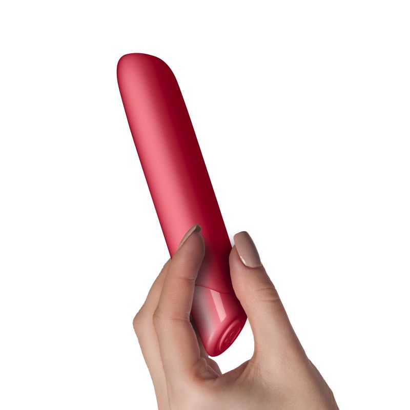 SugarBoo Cool Coral Bullet Vibe held in hand, showcasing sensory bullet vibe's vibrant design and touch surface.