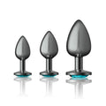 Cheeky Charms round metal butt plug kit in gunmetal with teal jeweled bases for sensual training.