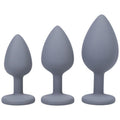 Silicone anal trainer set includes three grey spade butt plugs in varying sizes for beginners and anal play.