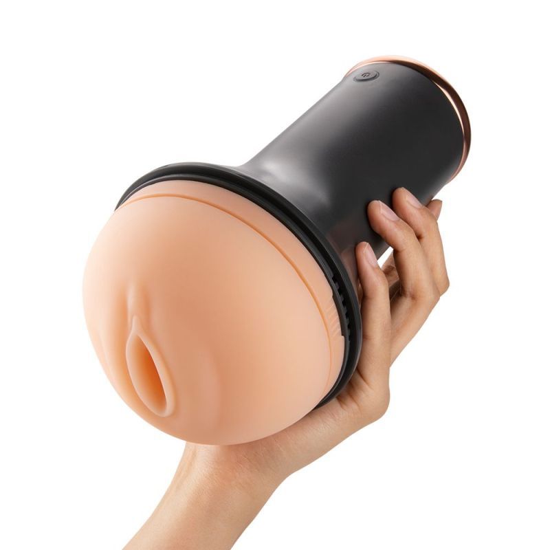 Inscup 1 heating vibration masturbator held in a hand, showcasing its soft silicone sleeve and ergonomic design.