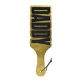 Designer spanking paddle with shimmering gold cut-out 'DADDY' design for naughty fun and stylish bedroom play.