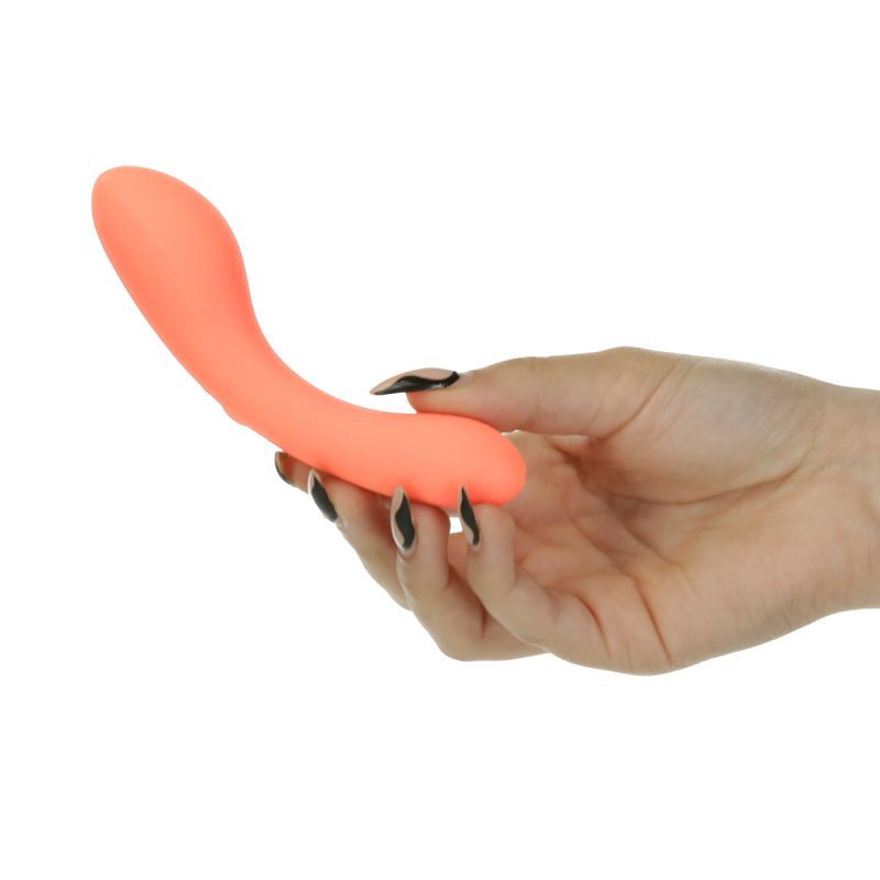 Mini Swan Wand vibrator in hand, showcasing its sleek design and vibrant glow orange color for pleasurable sensations.