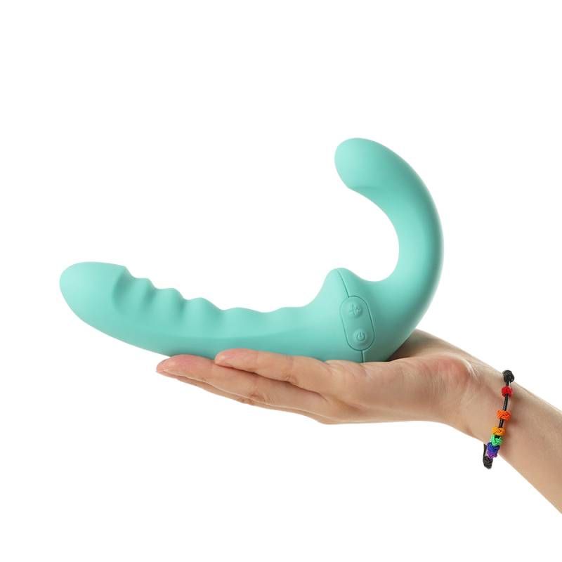 Rechargeable strapless strap on vibrator held in hand, featuring a curved design and buttons for control.