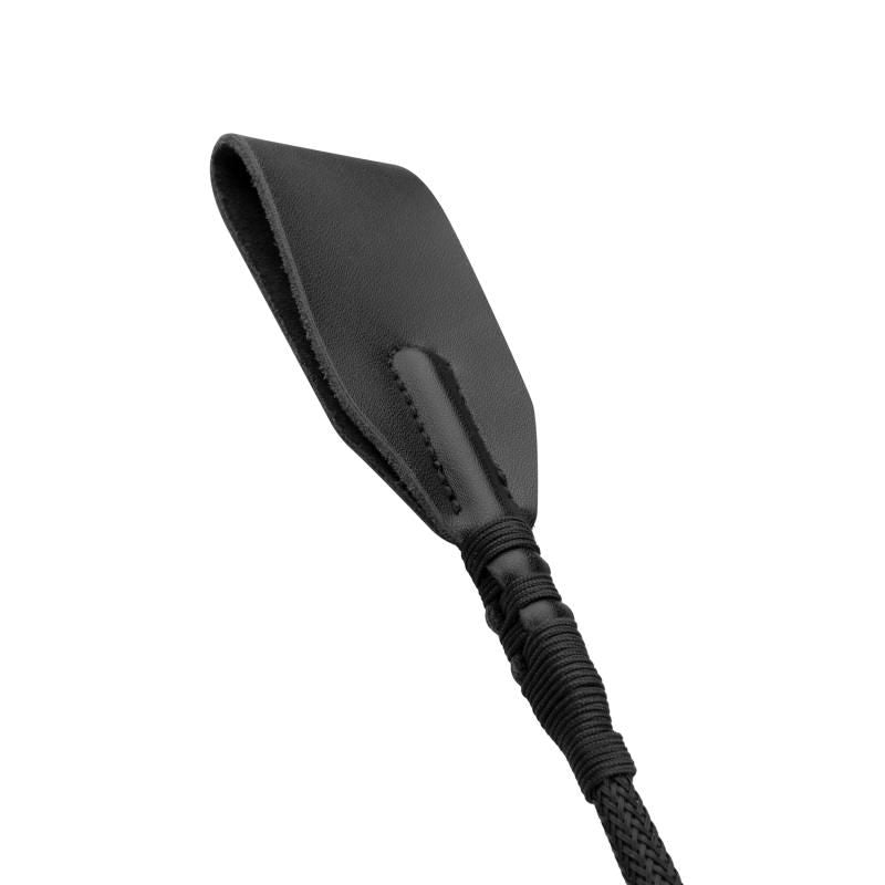 Close-up of a faux leather BDSM whip, featuring a comfortable grip and sleek black design, perfect for playful adventures.