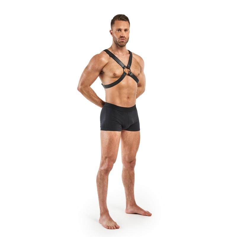 Model wearing an adjustable BDSM bondage harness made of faux leather, showcasing its design and fit.