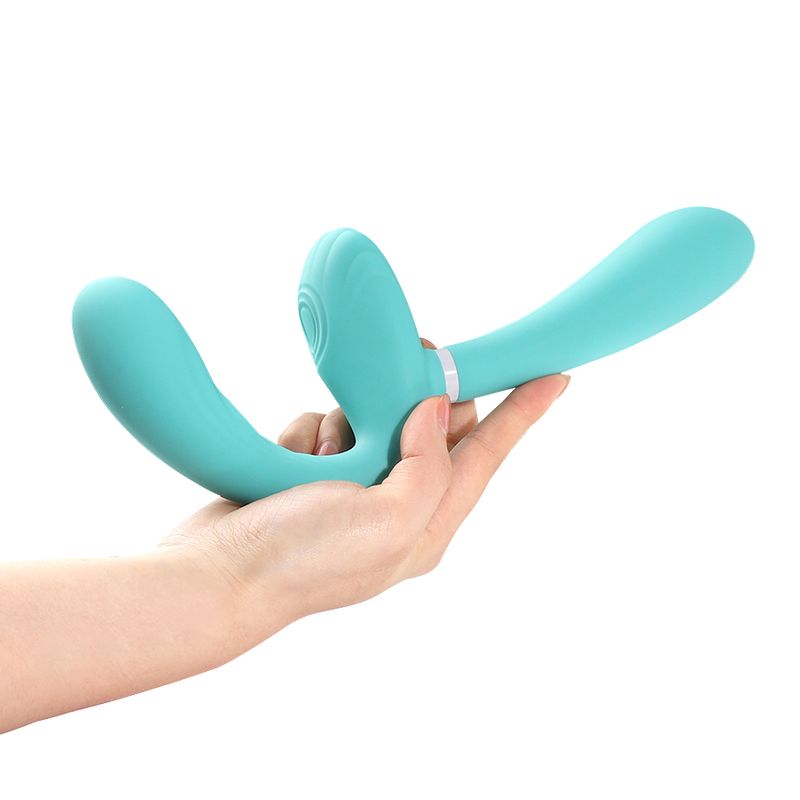 Hand holding the Sapphi detachable strapless double vibrator in teal silicone.