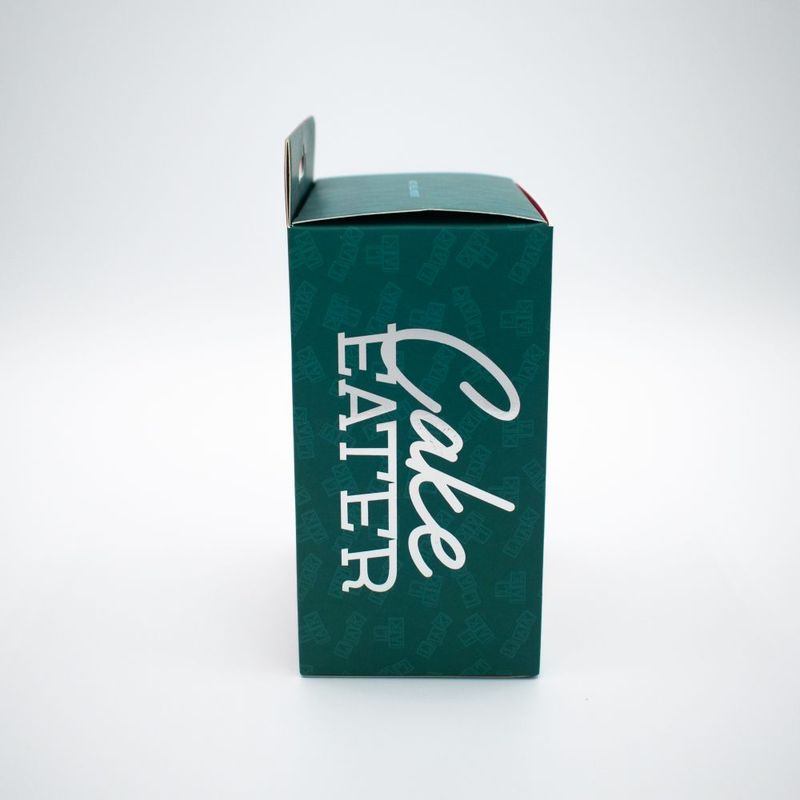 Cake Eater Clit Flicker Stimulator packaging box side view in teal and white design.