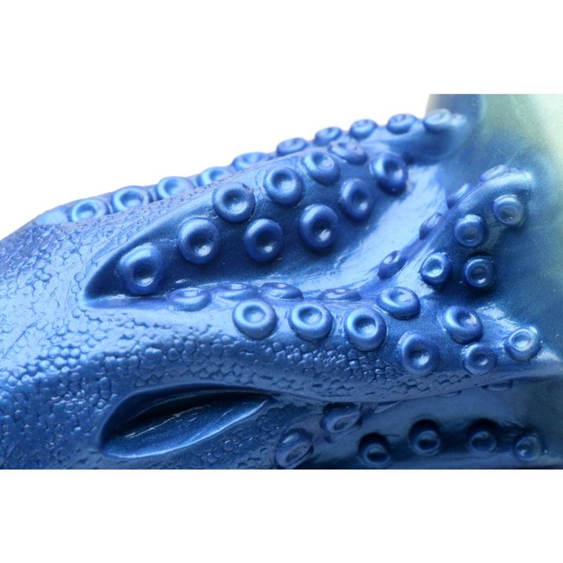 Close-up detail of the textured surface of the octopus silicone dildo featuring suckers and iridescent blue color.