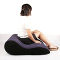 Large inflatable sex positioning mattress shown with a person sitting on it for enhanced comfort during intimate moments.