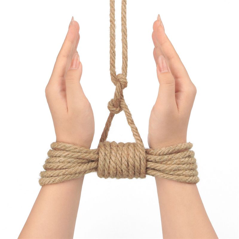 Hands tied with rustic hemp bondage rope showcasing its texture and grip for traditional bondage.