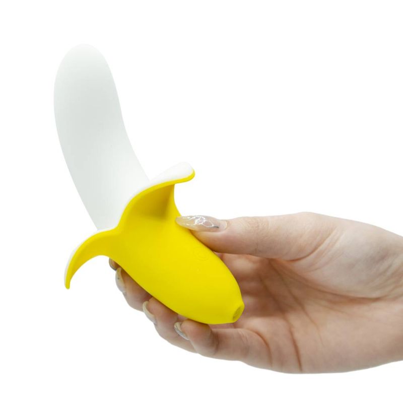 Silicone slimline vibrator massager in yellow banana shape held in hand, showcasing smooth design and ergonomic features.