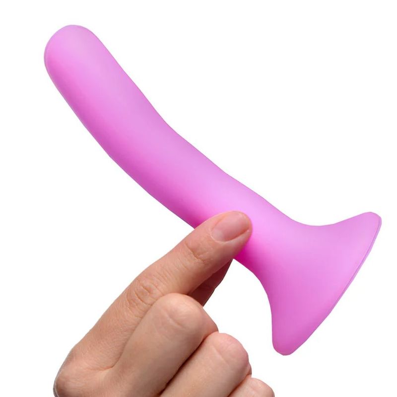 Pink Silicone Strap-On Dildo Small held in hand with a comfortable design for intimate pleasure.