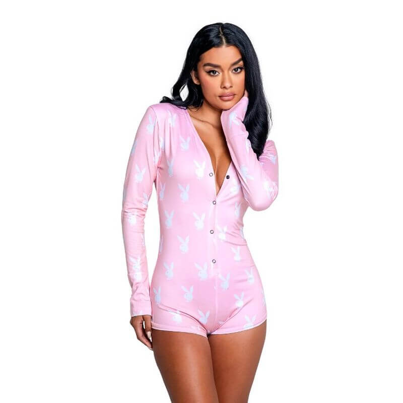 Model wearing pink slumber bunny romper featuring long sleeves and bunny logo.