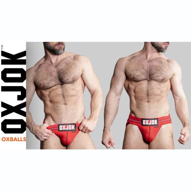 Oxballs Slingjock Upthrust Slider-Strap Jock Black Iron worn by a muscular man showcasing its comfort and fit.