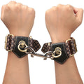 Deluxe handcuffs with spikes designed for stylish and comfortable restraint, featuring unique bronze detailing.