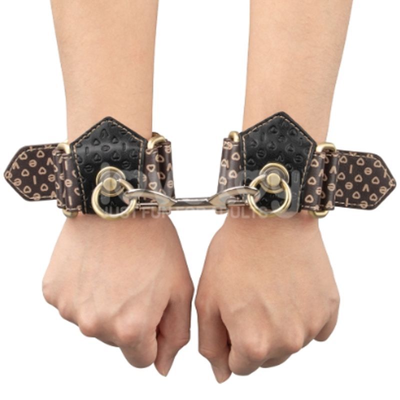 Deluxe handcuffs with spikes showcased on hands, designed for bold sophistication and comfort in play.