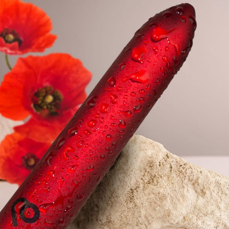 Poppy Red Rechargeable Bullet Vibrator with droplets, elegant design on display with poppy flowers.