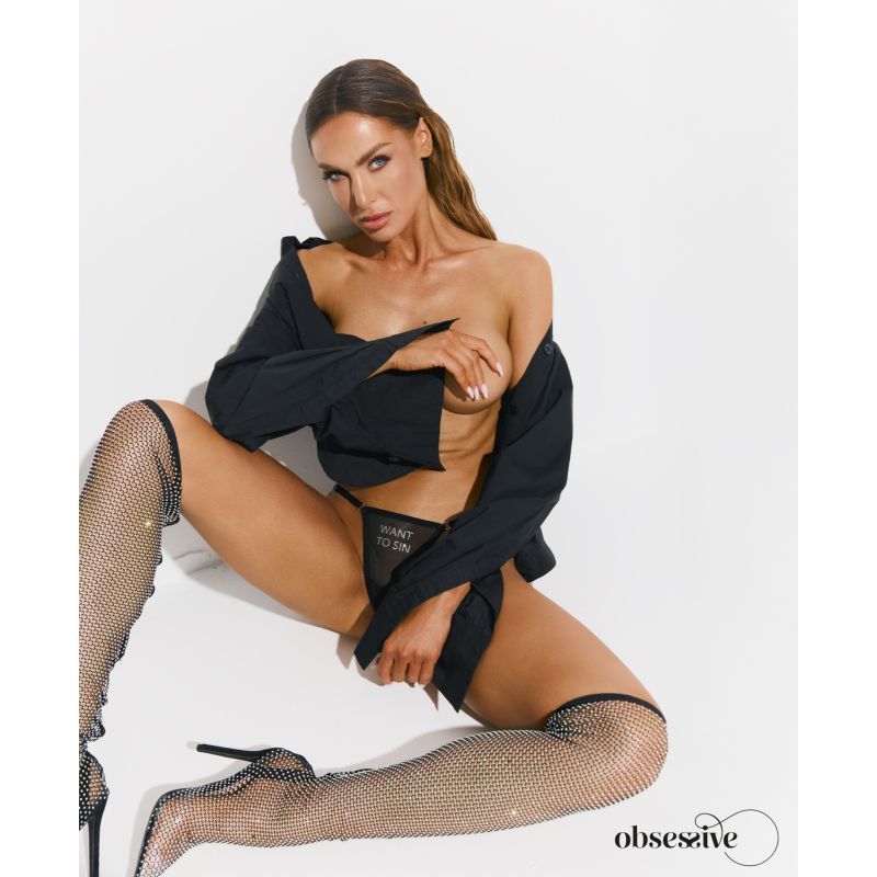 Model showcasing sheer black mesh thong and black shirt, exuding confidence and attitude.