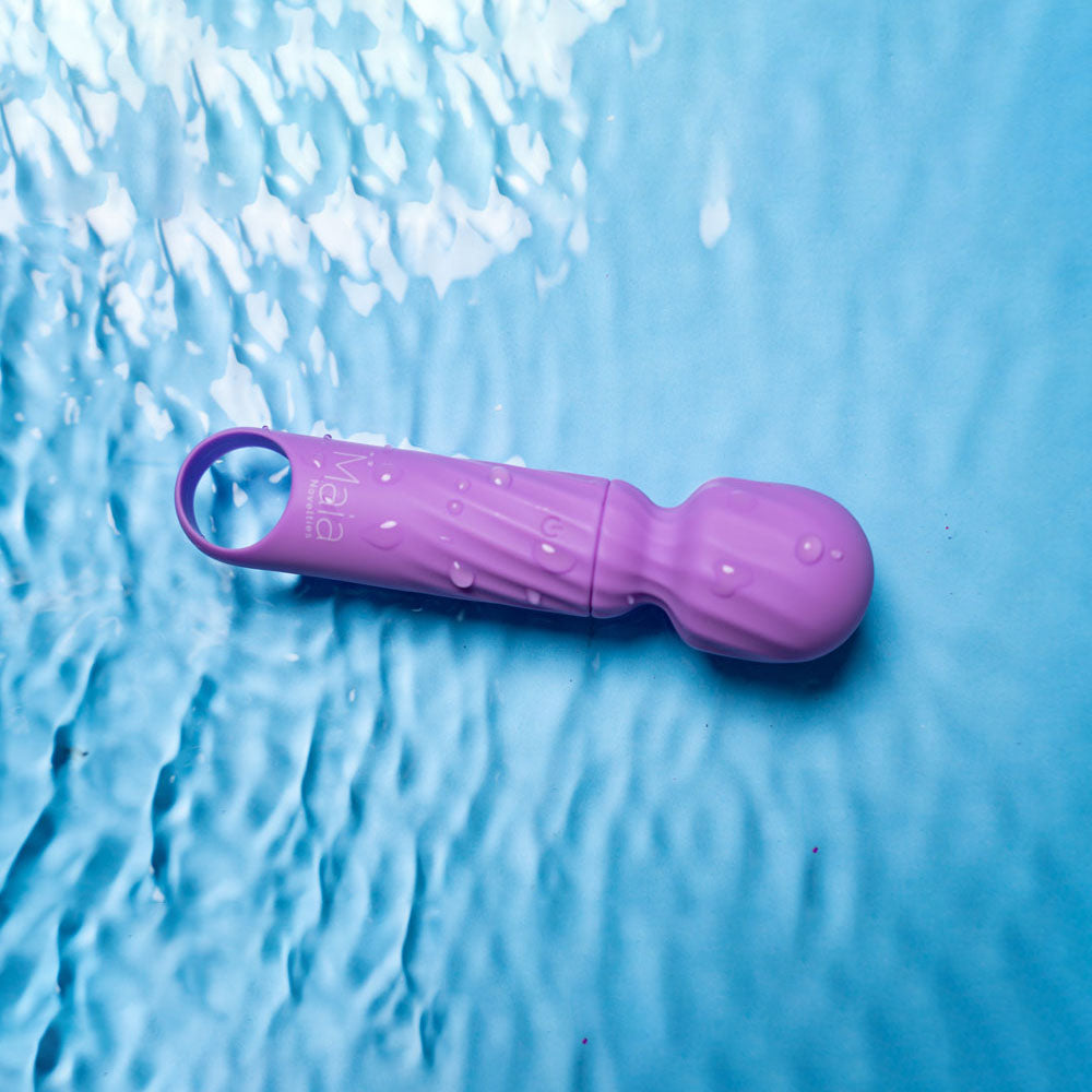Maia DOLLY -  -  12.7 cm USB Rechargeable Massage Wand on a blue surface with water droplets.