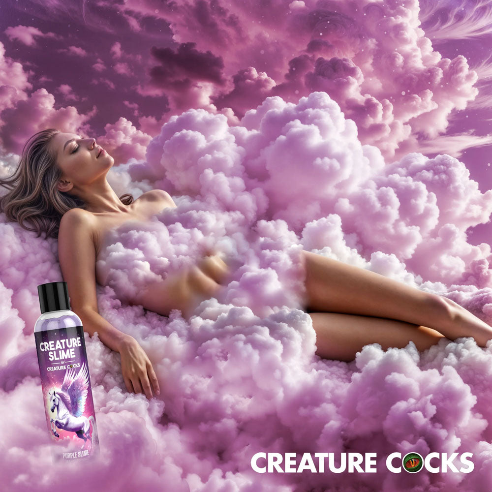 Creature Slime by Creature Cocks -  Slime -  Water Based Lubricant - 237 ml Bottle with model in purple cloud backdrop.