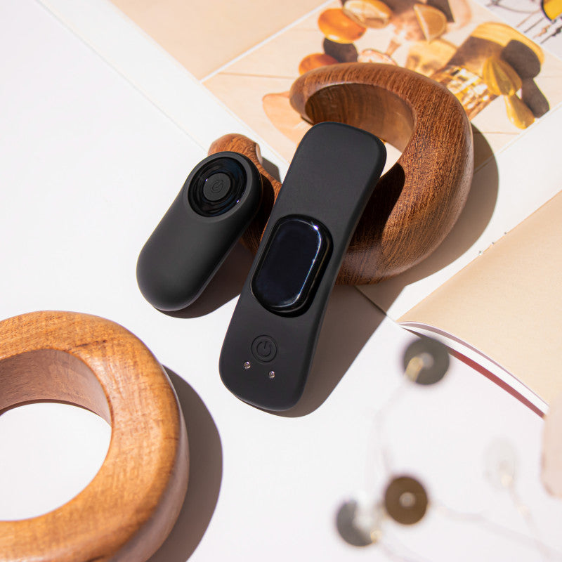 Temptasia Remote Control Panty Vibe - USB Rechargeable Panty Vibe with sleek black design on wood table.