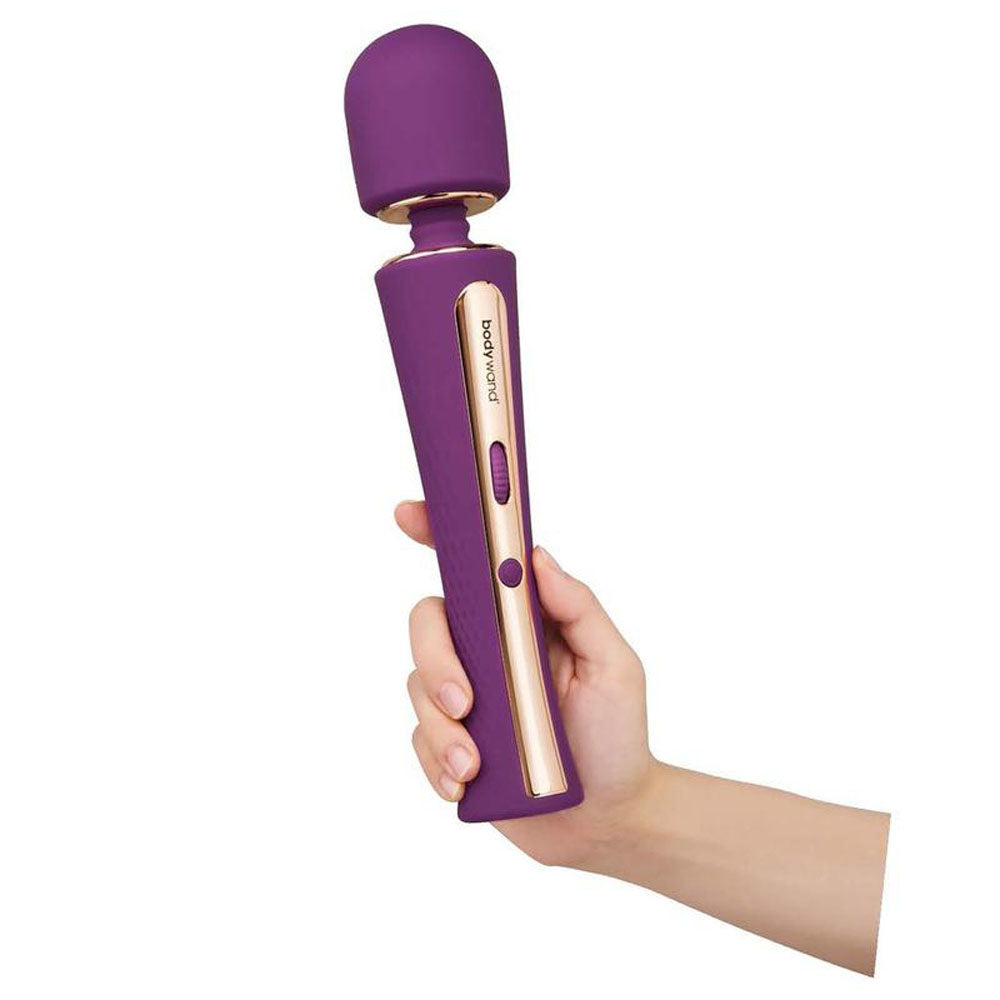 Bodywand Luxe Couture Wand - 28.2 cm USB Rechargeable Massage Wand in hand, featuring a purple design and control settings.