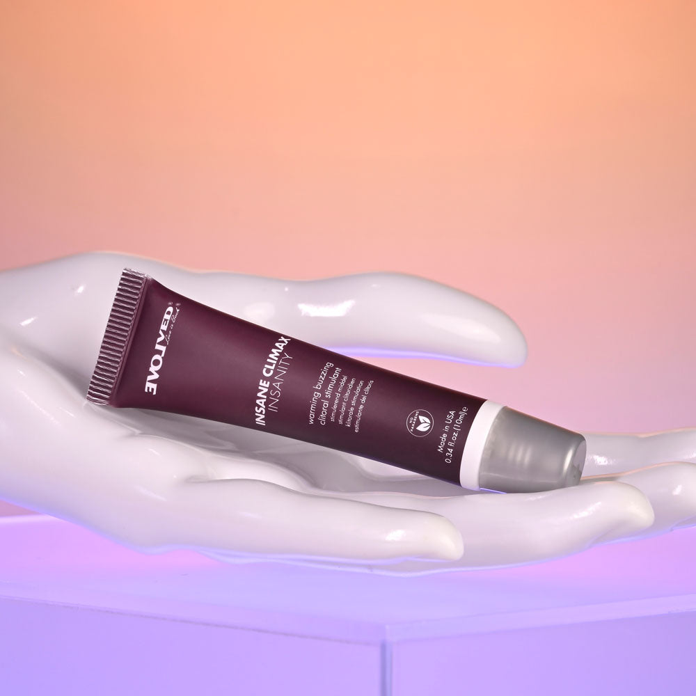 Evolved INSANE CLIMAX - INSANITY - Warming Buzzing Clitoral Stimulation Gel - 10 ml displayed on a hand