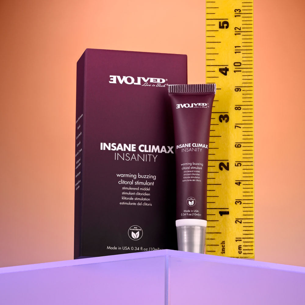 Evolved INSANE CLIMAX - INSANITY - Warming Buzzing Clitoral Stimulation Gel - 10 ml with measuring tape background.