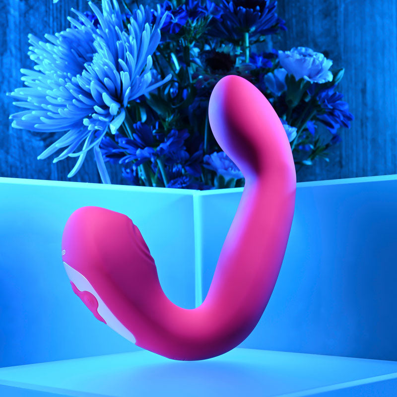 Evolved BUCK WILD -  USB Rechargeable Flicking Vibrator displayed with floral background and blue lighting.