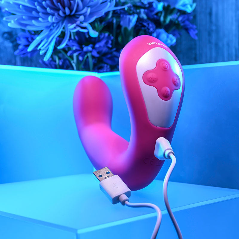 Evolved BUCK WILD -  USB Rechargeable Flicking Vibrator on a blue-lit surface with a USB cable.