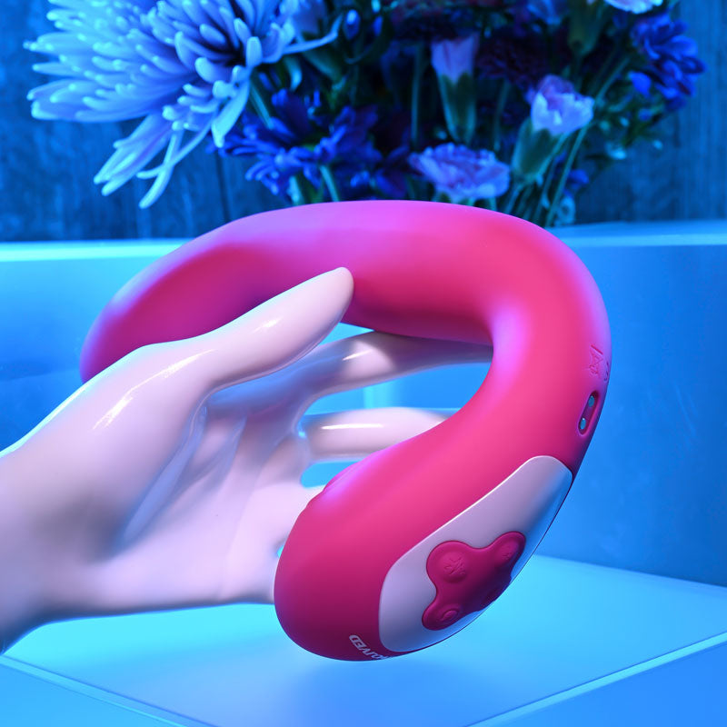 Evolved BUCK WILD -  USB Rechargeable Flicking Vibrator held in a hand, showcasing its ergonomic design.