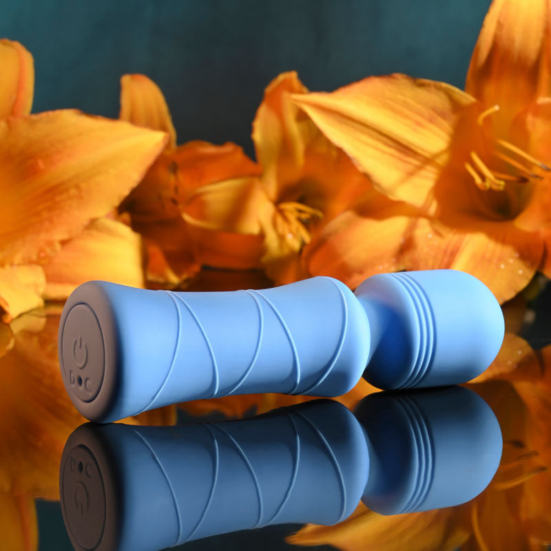 Evolved Out Of The  -  10.5 cm USB Rechargeable Mini Massager Wand on reflective surface with orange flowers.