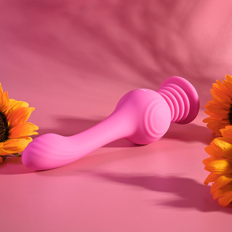 Evolved GYRO VIBE - 24.8 cm USB Rechargeable Super Vibrator on a pink background with sunflowers.