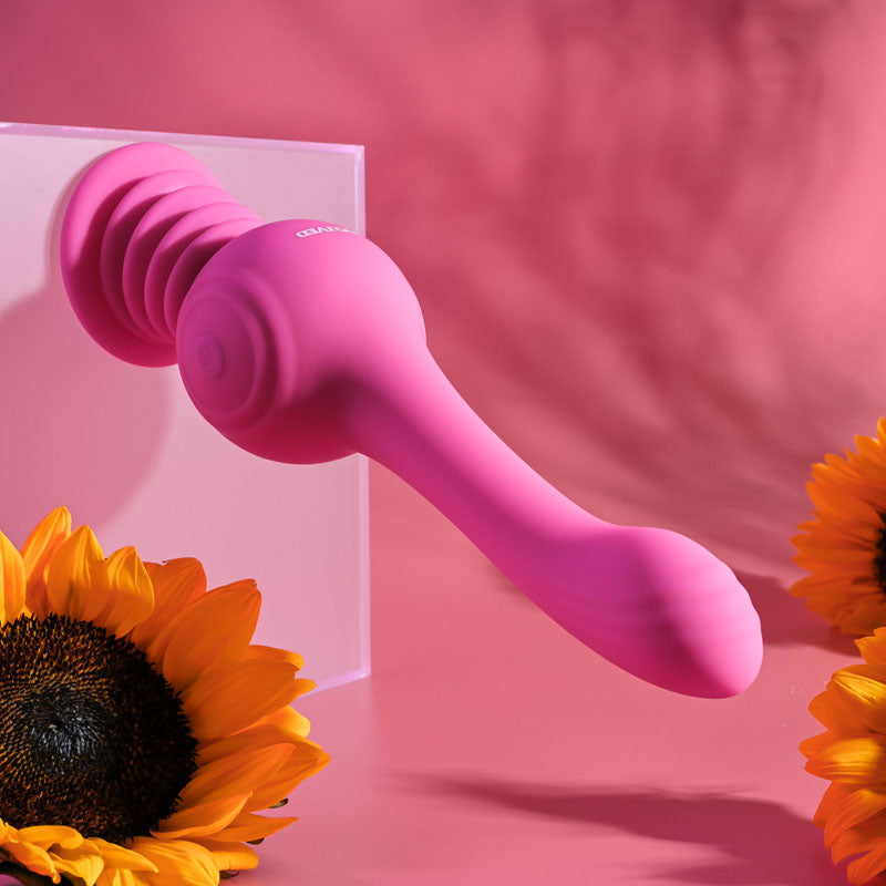 Evolved GYRO VIBE - 24.8 cm USB Rechargeable Super Vibrator against a bright pink background with sunflowers.