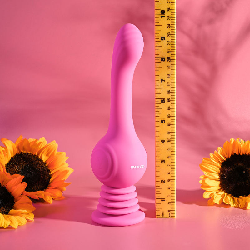 Evolved GYRO VIBE - 24.8 cm USB Rechargeable Super Vibrator next to a ruler, with sunflowers in the background.