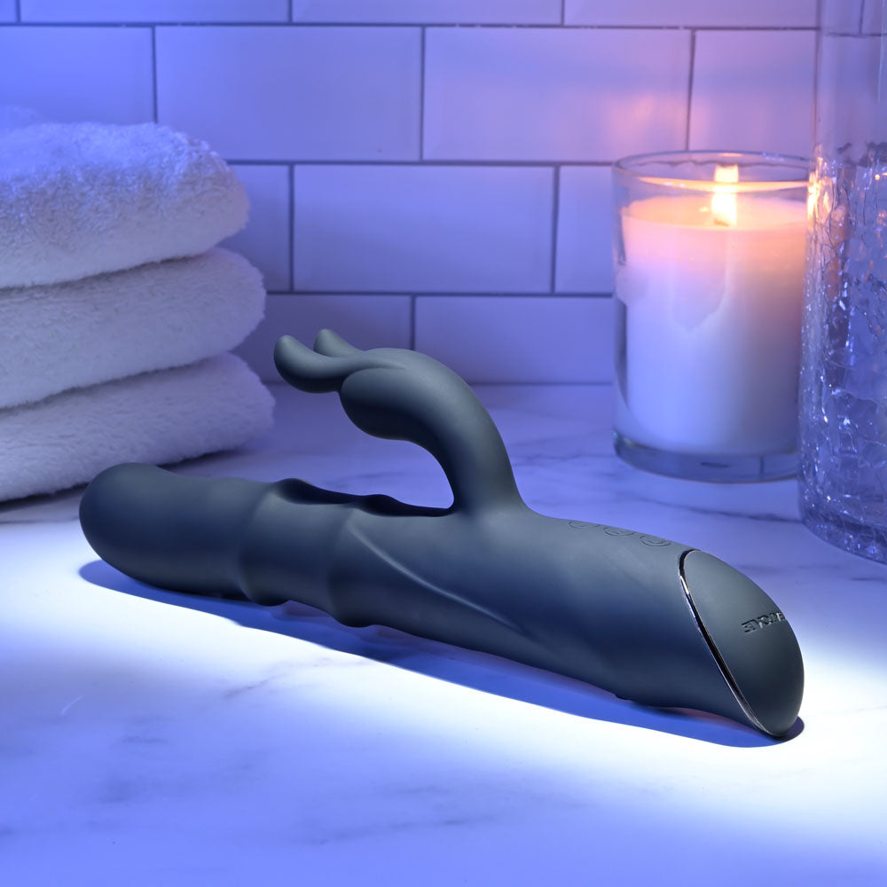 Evolved RINGMASTER - 23.1 cm USB Rechargeable Rabbit Vibrator on a marble surface with soft towels and a candle.
