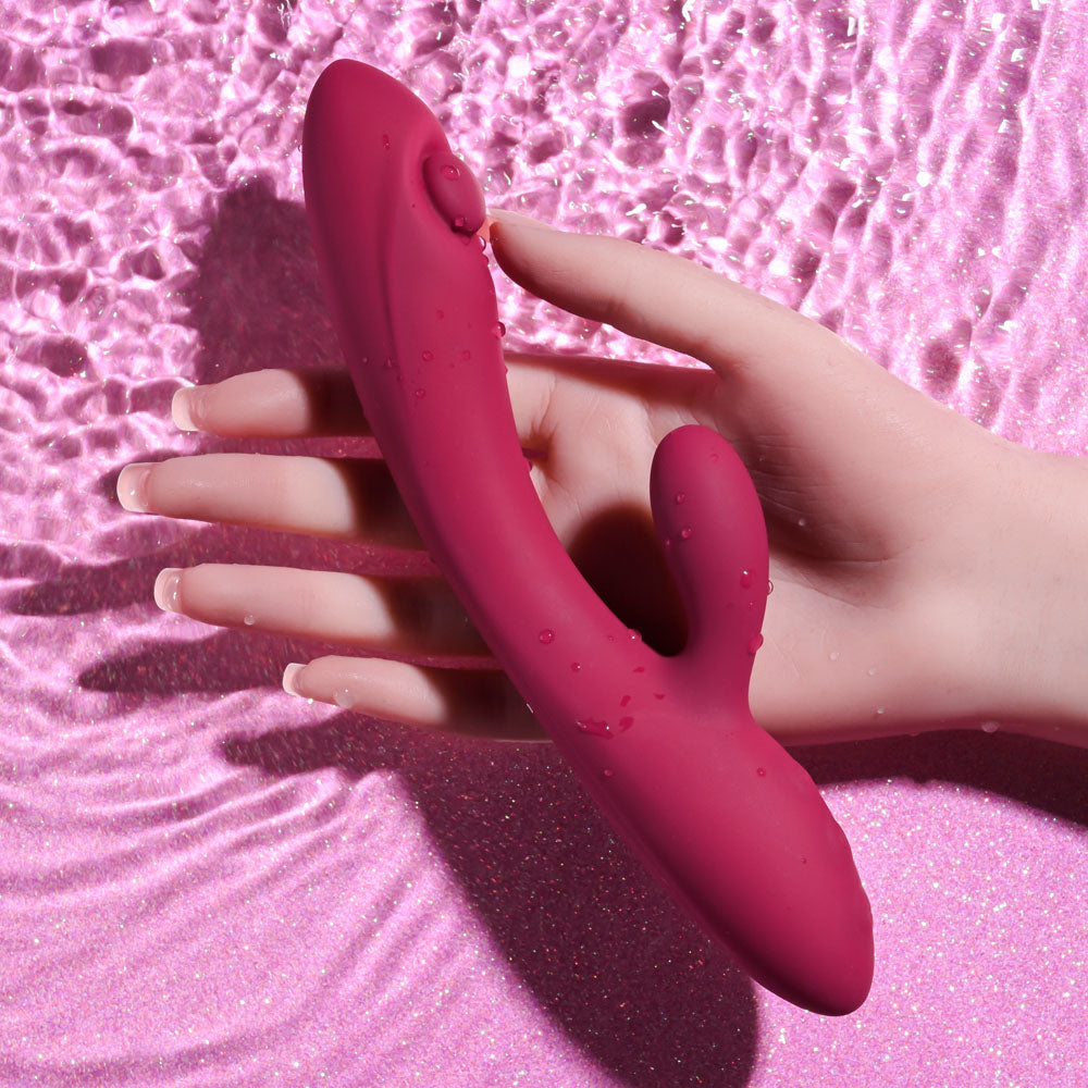 Evolved JAMMIN' G - Burgundy 20.1 cm USB Rechargeable Rabbit Vibrator in hand, showcasing its unique design and water-resistant feature.
