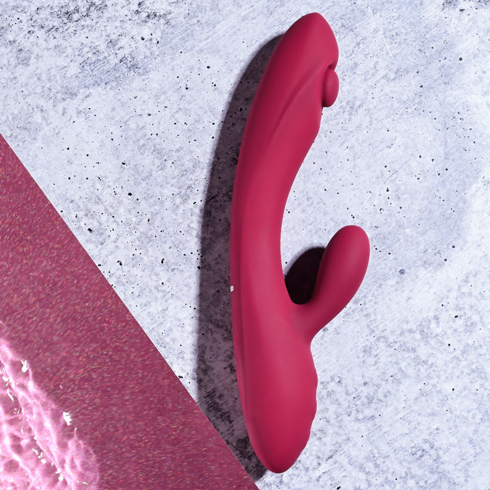 Evolved JAMMIN' G - Burgundy 20.1 cm USB Rechargeable Rabbit Vibrator against a textured background.